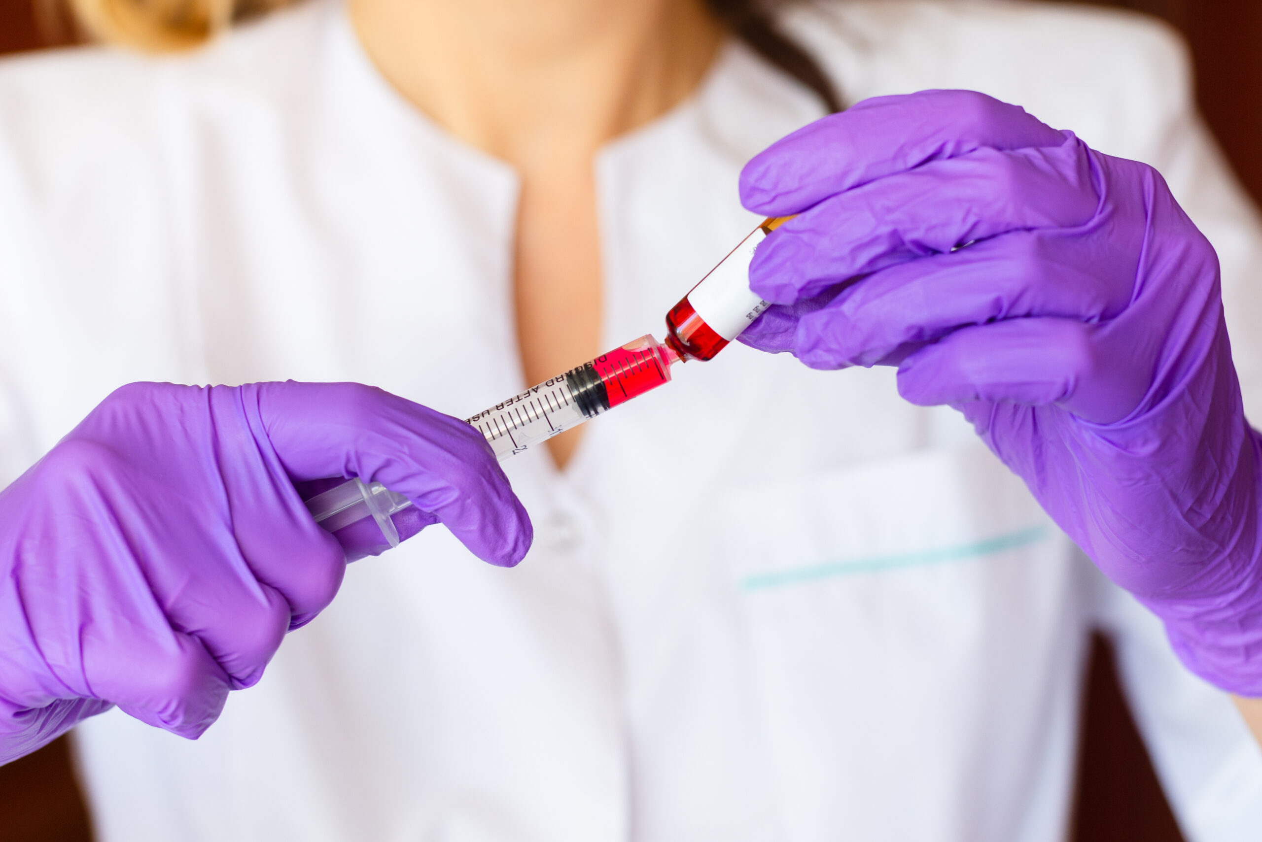 physician preparing vitamin b 12 shot