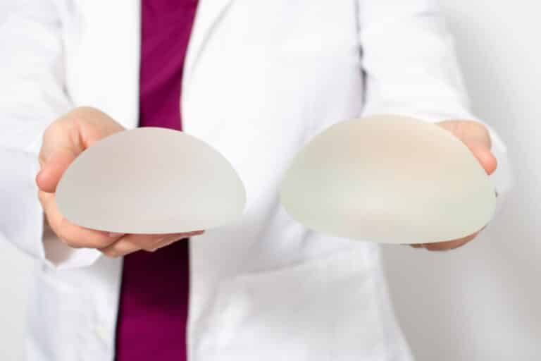 plastic surgeon holding saline implants